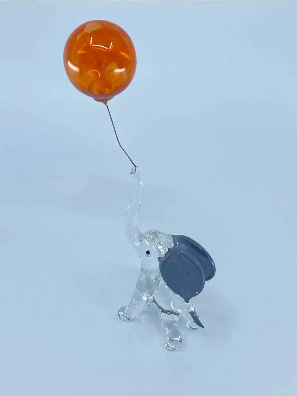 Hand-blown glass figurine resembles a circus elephant